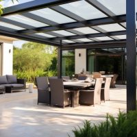 A stylish outdoor patio pergola that allows the sunlight to filter through its metallic structure.